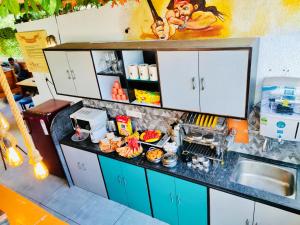a kitchen with a counter with food on it at Jugglers Backpack in Pune