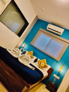a bedroom with a large bed with a window and a heater at Jugglers Backpack in Pune
