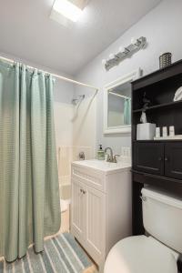 a bathroom with a toilet and a sink and a shower at Duplex in Alberta Art District in Portland +29 photos