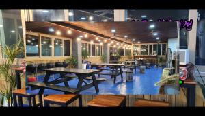 a restaurant with tables and benches in a building at Oedo Tour Pension in Geoje