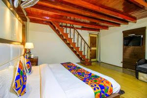 a bedroom with a bed with a staircase in it at FabHotel Moon II in Nainital