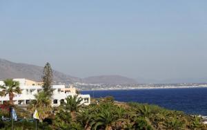 a view of the ocean and a white building at Studio in the Centre of Sissi in Sissi