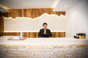 a man standing behind a counter giving a speech at Aabas Pokhara by Barahi Hospitality in Pokhara