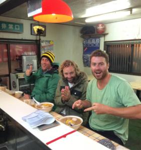 a group of people sitting at a counter in a restaurant at Hotel Senke in Myoko