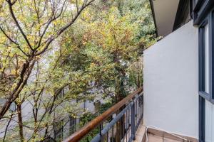 a balcony of a house with trees in the background at Lemon Rind - 16 Eikehoff in Stellenbosch