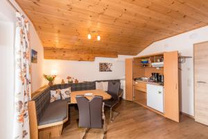 a kitchen and a dining room with a table and chairs at Kirchgassers Landhäusl in Ramsau am Dachstein