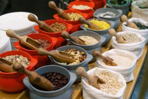 a table filled with bowls of different types of food at Park Hyatt Vienna in Vienna