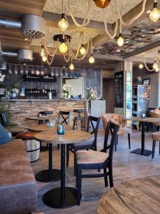 a restaurant with tables and chairs and a bar at Havshotellet in Malmö