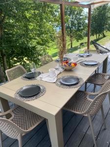 a white table with chairs on a deck at Jana House Oriovac in Oriovac