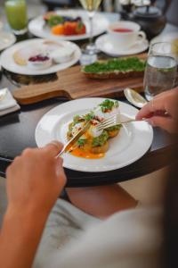 a person sitting at a table with a plate of food at Park Hyatt Vienna in Vienna