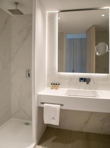 a white bathroom with a sink and a mirror at Atlantica Aqua Blue in Protaras