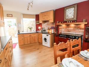 a kitchen with wooden cabinets and a dishwasher at Bellevue in Barnard Castle