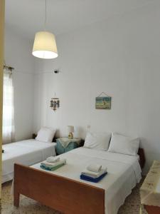 a bedroom with two beds with towels on them at Matina's agora apartment with Terrace in Leonidion