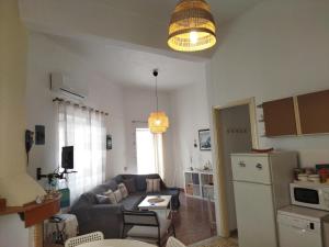 a living room with a couch and a table at Matina's agora apartment with Terrace in Leonidio