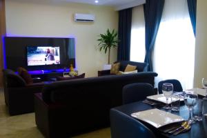 un soggiorno con divano e TV di Stiyos Shortlet homes- Tastefully Furnished 3 Bedroom a Lagos