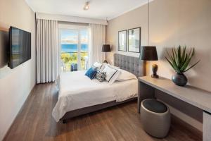 a bedroom with a bed and a view of the ocean at Hotel Osam - Adults Only in Supetar +26 photos