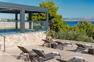 a patio with chairs and a view of the water at Hotel Osam - Adults Only in Supetar
