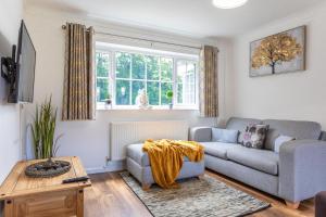 a living room with a couch and a table at Maunsell House - Lovely central home near Designer Outlets & town with parking in Ashford