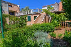 a house with a balcony on the side of it at Apartment in Veli Losinj 14995 in Veli Lošinj