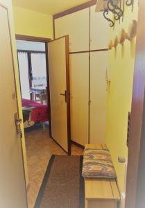 a hallway with a door and a bench in a room at Il nido di Asia CIR N0310 in Breuil-Cervinia
