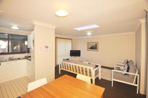 a living room with a dining table and a kitchen at Katoomba Townhouses in Katoomba