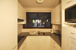 a small kitchen with a sink and a window at Katoomba Townhouses in Katoomba