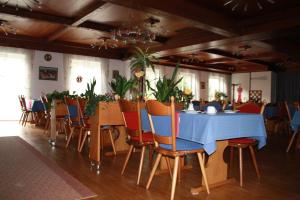 a dining room with a blue table and chairs at Hotel Gasthaus Wangerhof in Augsburg