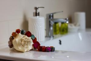 a tooth toy sitting on a bathroom counter next to a sink at Cocastelli 1 - Smart Holiday in Mantova