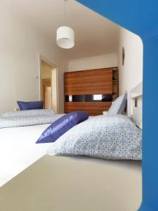 deux lits avec des oreillers bleus dans une chambre dans l'établissement Centrum, à Sarajevo