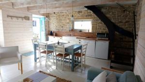 a kitchen with a table and chairs in a room at Jolie maison de Pêcheur - Sweet Fisherman Cottage in Saint-Philibert