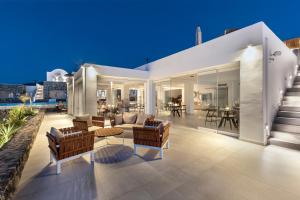 a living room and dining area of a house at Secret View Hotel in Oia