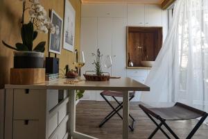 a kitchen with a table and a chair in a room at #outofboxproject tiny-home and garden house in Timişoara