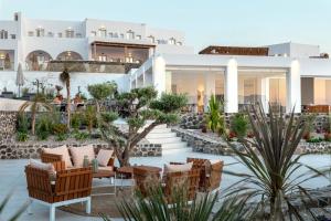 a view of a resort with chairs and tables at Secret View Hotel in Oia