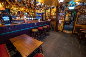 a bar with tables and stools in a room at The Rusty Mackerel in Teelin