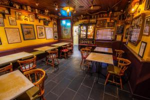 a bar with wooden tables and chairs in a restaurant at The Rusty Mackerel in Teelin