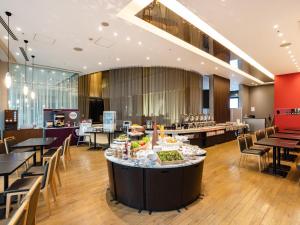 a restaurant with a table with food on it at Tenza Hotel at Hakata Station in Fukuoka