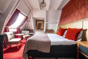 een slaapkamer met een groot bed met rode kussens bij Herberg De Swaen in Vuren