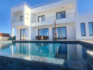 a swimming pool in front of a house at Eva Luxury Villa in Lachi