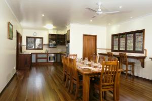 a kitchen and dining room with a wooden table and chairs at The Summit Bed & Breakfast in Atherton
