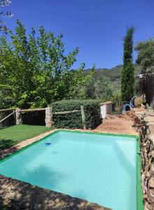 a large blue swimming pool in a yard at 5 bedrooms villa with private pool enclosed garden and wifi at Sorihuela del Guadalimar in Sorihuela del Guadalimar
