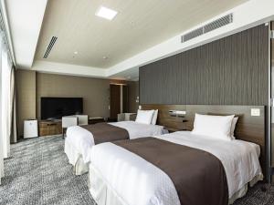 מיטה או מיטות בחדר ב-Tenza Hotel at Hakata Station
