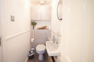 ein kleines Bad mit WC und Waschbecken in der Unterkunft Sea Gem- Beautiful family home with stunning sea views & garden in Tenby