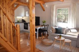 a living room with a couch and a table at ACTIVFARM DOMKI NA KASZUBACH Domek Piotruś in Gliśno