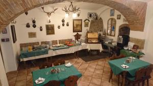 a dining room with two tables with green table cloth at Chebsky dvur - Egerlander Hof in Karlovy Vary +30 photos