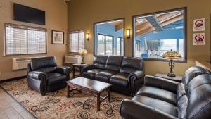 a waiting room with leather furniture and a flat screen tv at SureStay Hotel by Best Western Ellensburg in Ellensburg