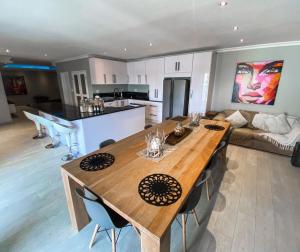 a kitchen and living room with a large wooden table at The Penthouse in Walvis Bay