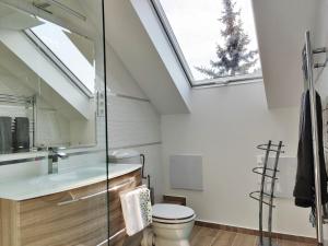 a bathroom with a sink and a skylight at Dali Apartment Szentendre in Szentendre +18 photos