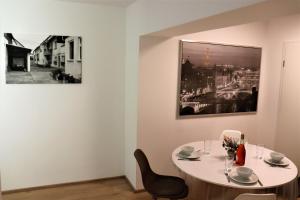uma mesa e cadeiras num quarto com uma fotografia na parede em Apartment "Anne" in ehemaliger Schuhfabrik em Herxheim