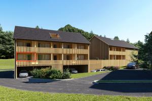 une grande maison avec des voitures garées dans une allée dans l'établissement SMART Apartments Mellau, à Mellau