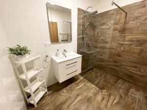 a bathroom with a white sink and a shower at apartmán Dream Residence in Bojnice +24 photos